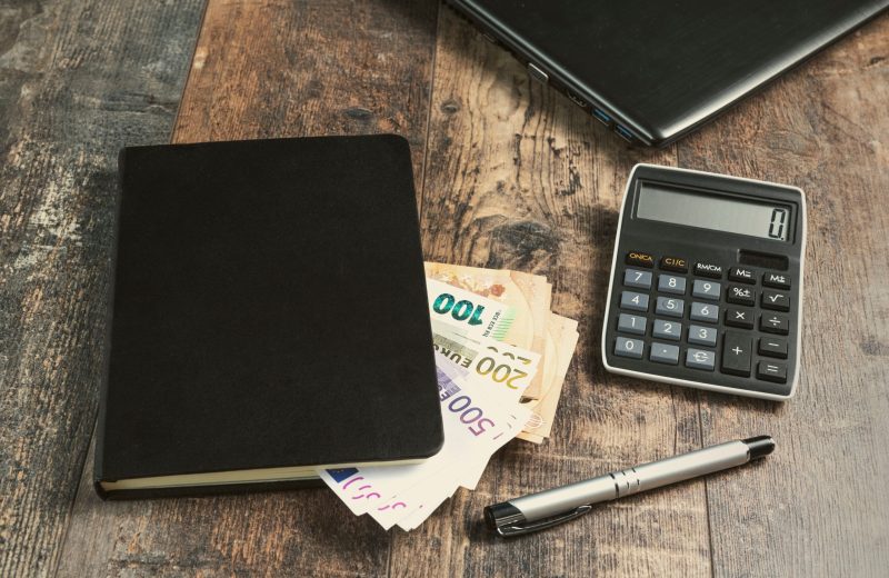 Accounting,Book,Fragment,Of,An,Account,Device,With,Euro,Banknotes
