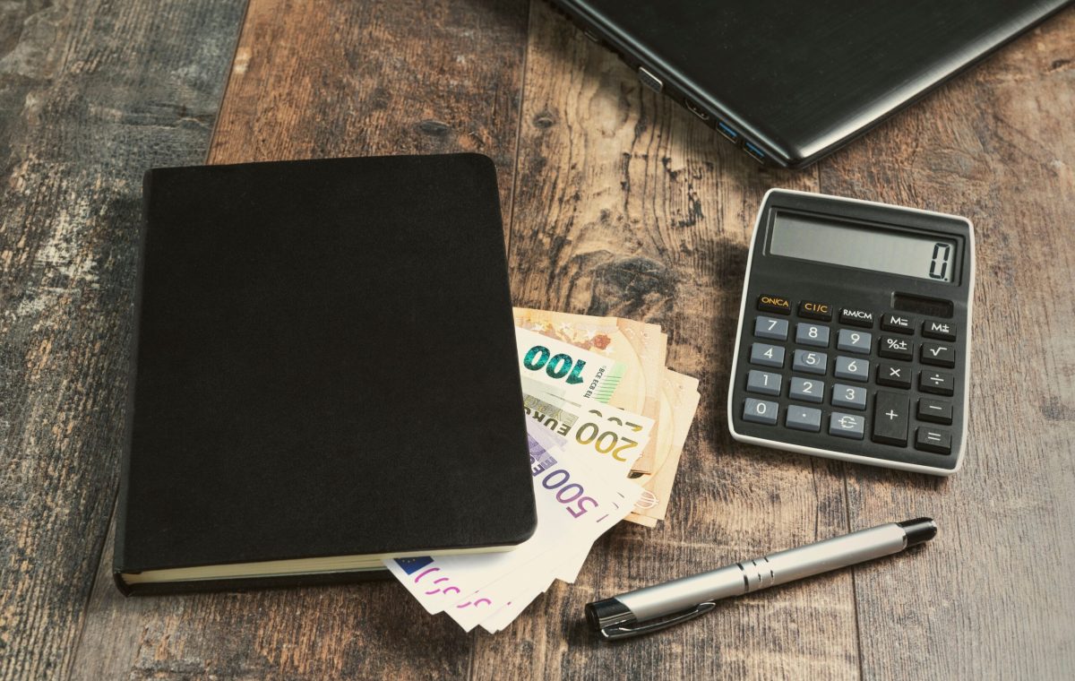 Accounting,Book,Fragment,Of,An,Account,Device,With,Euro,Banknotes